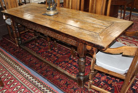 An oak refectory style dining table with cleated four-plank top L.210cm